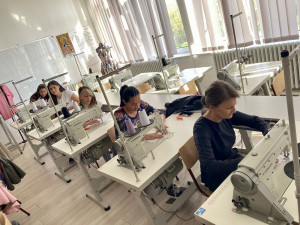 students doing tailoring using sewing machine in a class room