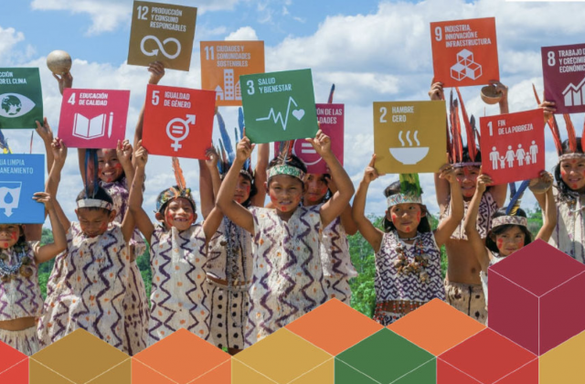 An image of children holding posters corresponding to the different SDG logos