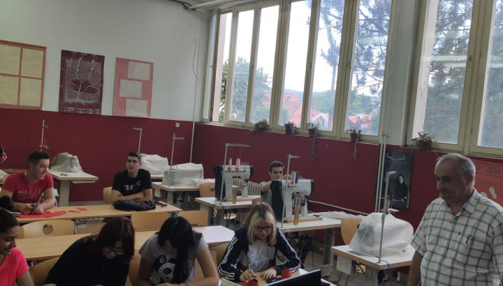 image of students learning sewing in a classroom