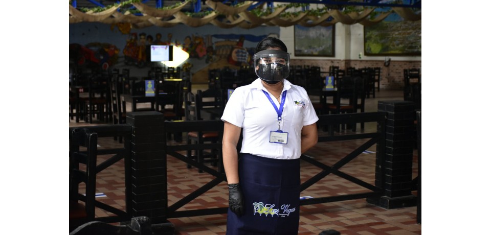 An image of a woman wearing a mask and face shield at Baranquilla's Opportunities Center