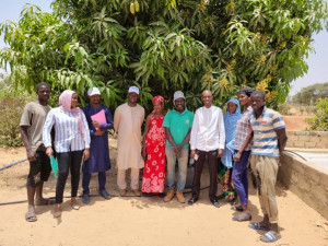 Image of beneficiaries standing in front of trees