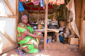 A woman sits in front of a food stall in southern Chad.