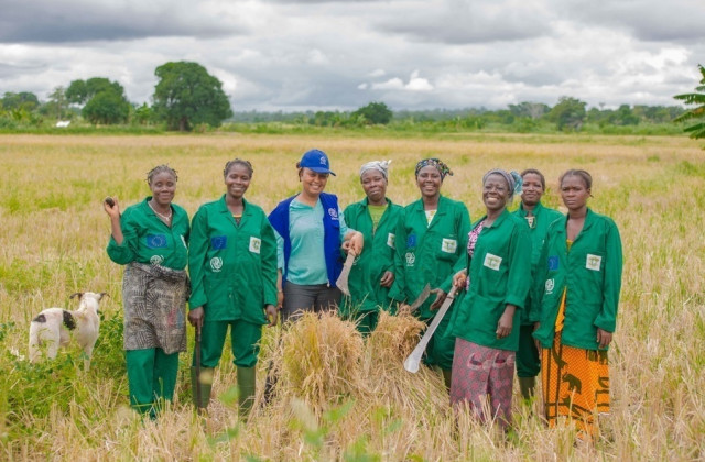 image of a group of women standing in the farmland and smiling to the camera