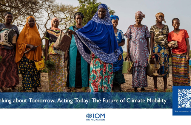 Thinking about tomorrow, Acting today: The future of climate mobility. A group of African women stand with watering cans. The woman in front is pouring water onto the ground. 