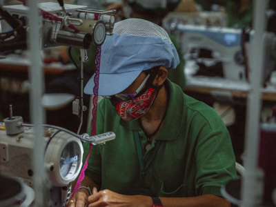 A factory employee working on a sewing machine