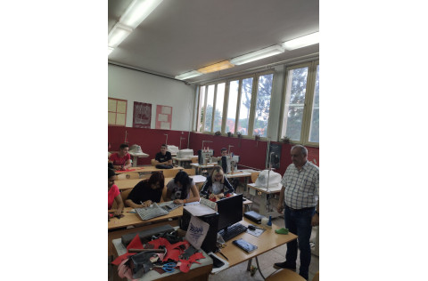 image of students learning sewing in a classroom
